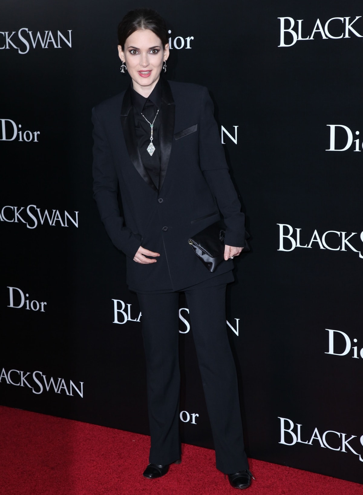 Winona Ryder styled a black Givenchy Resort 2011 suit with Stephen Russell jewelry and a Lanvin Ouloulette satin brooch clutch