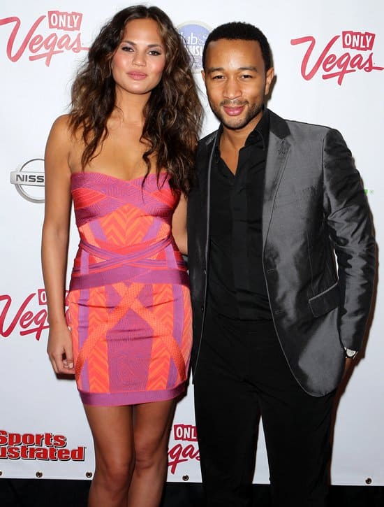 John Legend and Chrissy Teigen pose for the cameras upon arriving at Club SI Swimsuit hosted by Vanity
