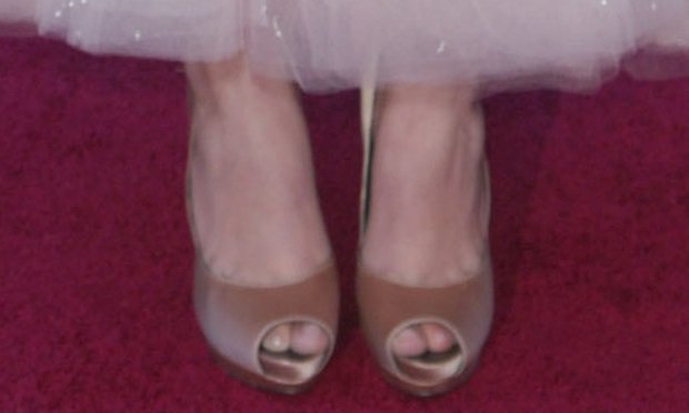 Hailee Steinfeld's feet in nude satin Ferragamo pumps