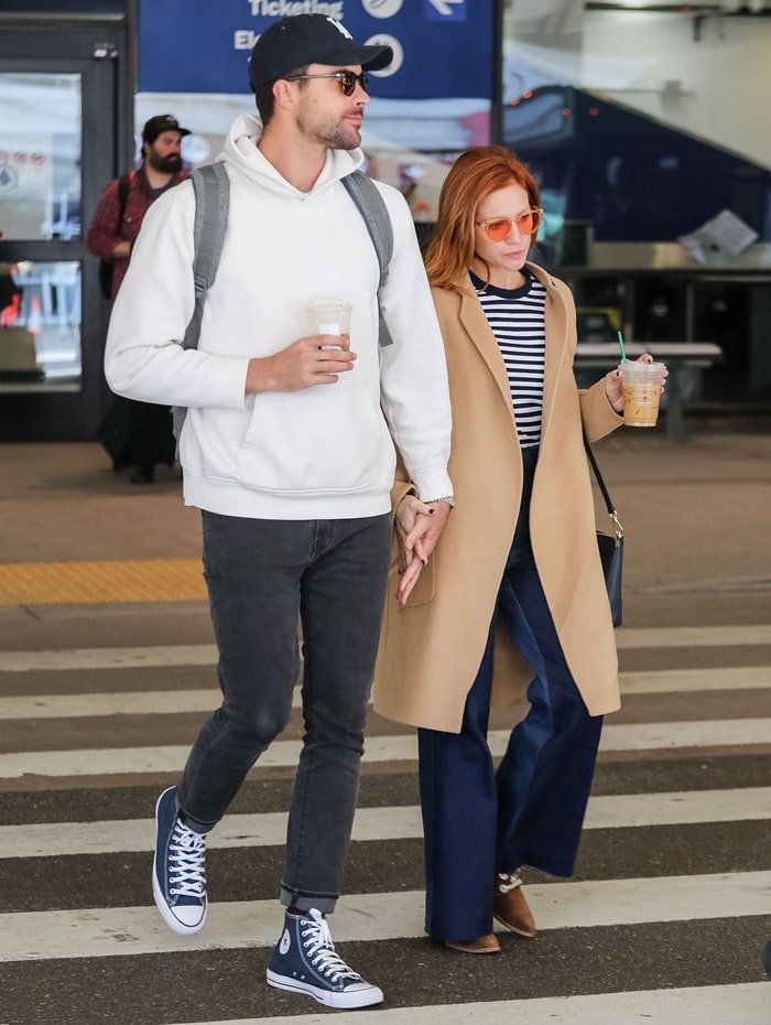 Brittany Snow and Tyler Stanaland exude casual chic as they hold hands at LAX Airport in Los Angeles on February 5, 2020