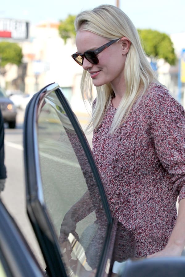 Chic and cozy, Kate Bosworth is effortlessly stylish in her snug cable-knit sweater, complemented by sleek sunglasses – a perfect blend of comfort and glamour