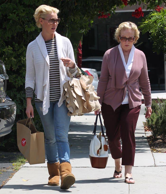 Carrying a brown paper bag from Il Piccolino restaurant, Katherine Heigl keeps it casual yet stylish in a striped top, white knit cardigan, skinny jeans, and cozy chestnut UGG boots while shopping in West Hollywood with her mother, Nancy, on May 20, 2011