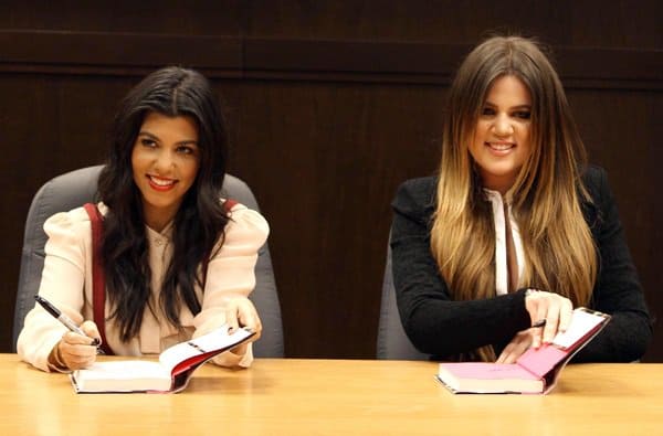 Khloe and Kourtney Kardashian captivate fans at a book signing for 'Dollhouse' in Los Angeles, showcasing their signature Kardashian style with poise and elegance