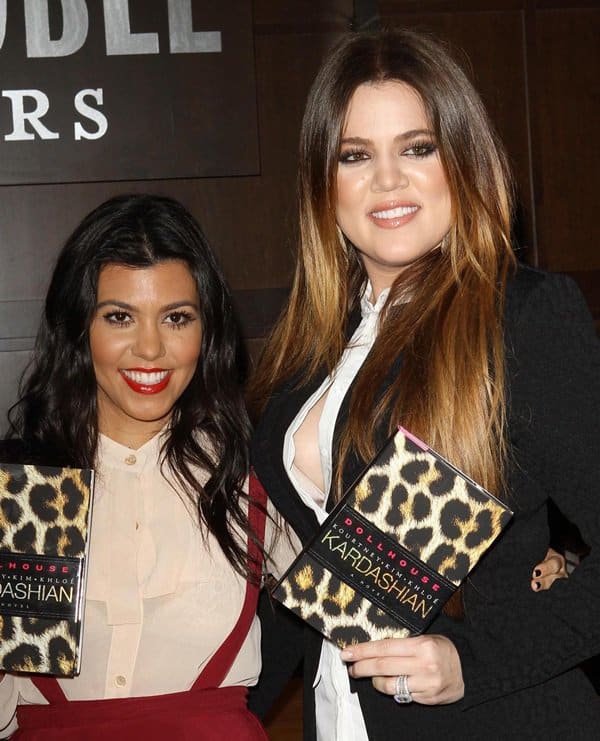 The Kardashian sisters, Khloe and Kourtney, radiate confidence and style during the promotion of their collaborative fiction, 'Dollhouse', exemplifying their fashion-forward charisma