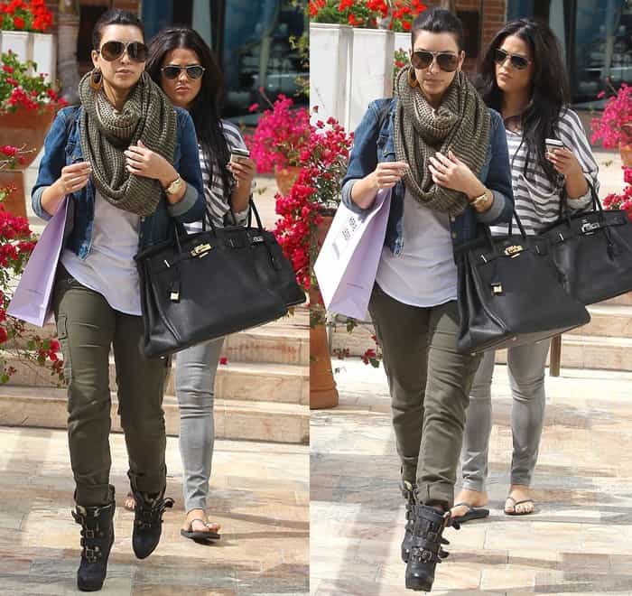 Kim Kardashian pairs army green skinny cargo pants with a cropped denim jacket, layering up with a chunky scarf and finishing the look with edgy Burberry Aviator buckle boots that add a bold, military-inspired touch