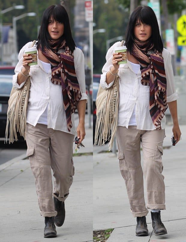 Pregnant Selma Blair steps out in a chic, casual look featuring a white shirt, paired with a stylish long safari-inspired scarf, cargo pants, and sleek black boots