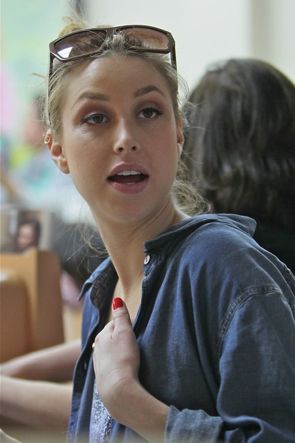 Whitney Port keeps it laid-back yet polished at a Beverly Hills nail spa, rocking a denim shirt, tousled updo, oversized sunglasses, and a fresh red manicure