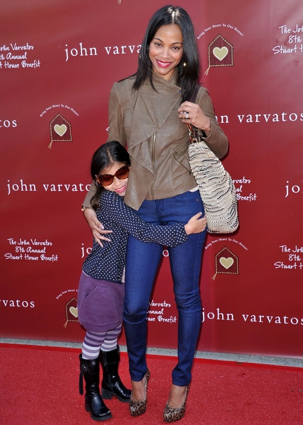 Zoe Saldana posing with her daughter for the cameras at the John Varvatos Eighth Annual Stuart House Benefit held at the John Varvatos Store in West Hollywood, California, on March 13, 2011