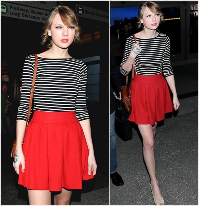 On February 22, 2011, Taylor Swift made a stylish entrance at LAX airport, donning a chic ensemble consisting of a Zara striped shirt, a vibrant red skirt, and elegant nude ballet flats