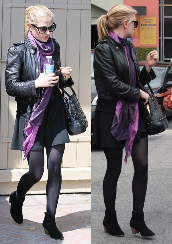 Anna Paquin masters edgy-chic style in a leather jacket, a bold purple scarf, sheer tights, and black suede ankle boots—perfect for a polished yet effortless street look
