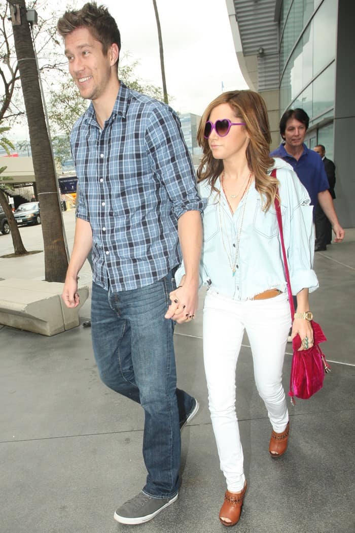 Scott Speer and Ashley Tisdale hold hands as they arrive at a Los Angeles Lakers game held at Staples Center