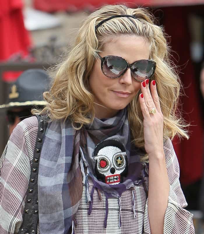 Heidi Klum wears a skull-embroidered plaid scarf