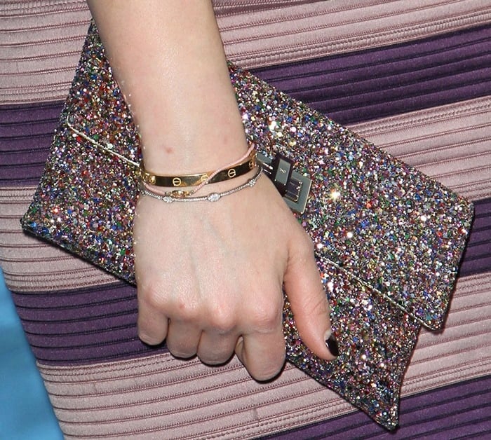Hilary Duff shows off her glittery accessories — and chipped black manicure — on the blue carpet