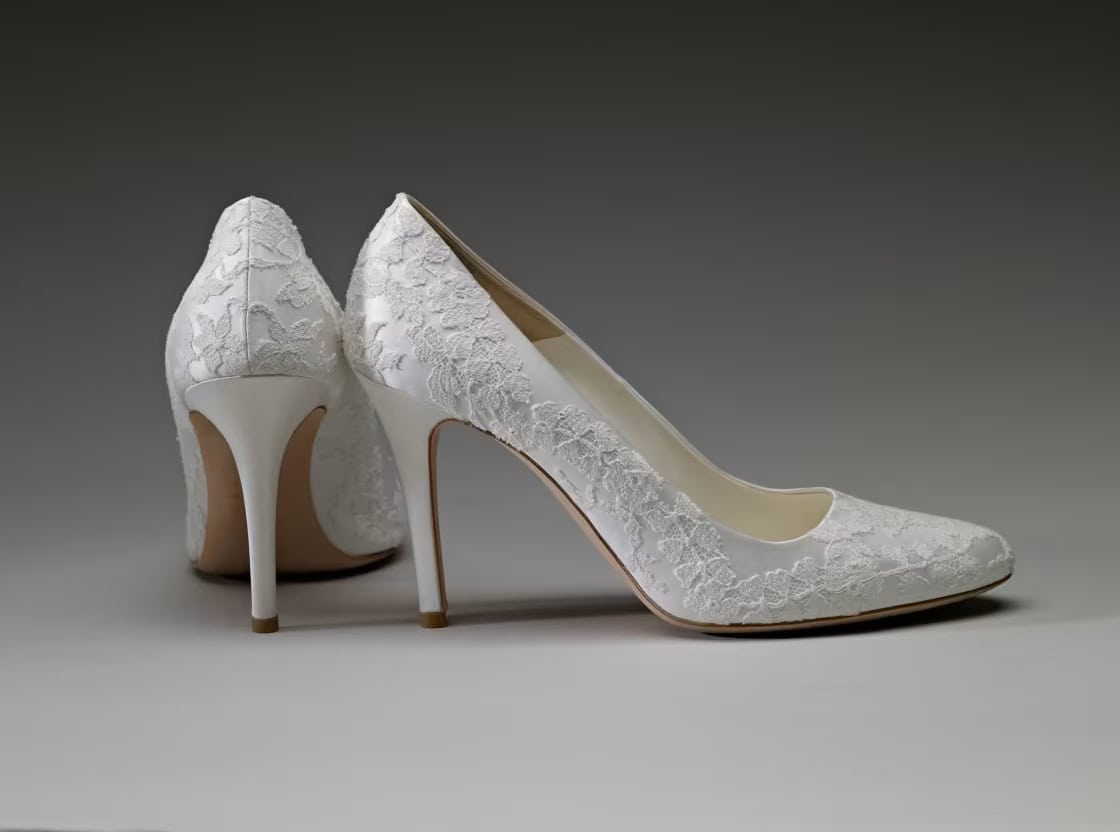 The official Alexander McQueen wedding shoes, crafted from ivory duchesse satin and featuring lace hand-embroidered by the Royal School of Needlework to perfectly match the bride's gown
