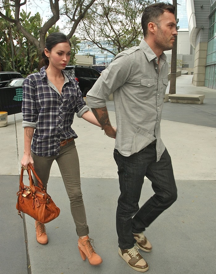 Megan Fox in a "working man"-inspired outfit consisting of a plaid shirt and olive skinny jeans