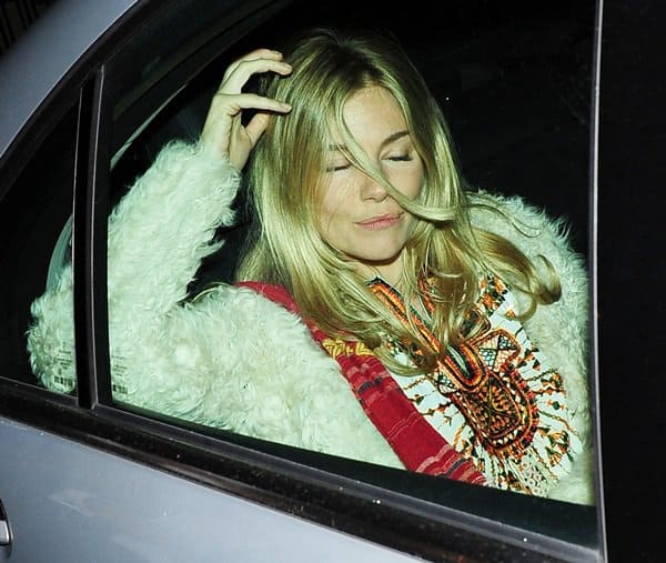 Capturing the essence of boho-chic, Sienna Miller leaves the Theatre Royal Haymarket, her outfit perfectly embodying the free-spirited vibe with a flowing blouse and artisanal sling, after her performance in 'Flare Path' on April 11, 2011