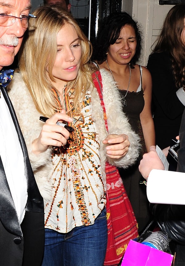 Sienna Miller exudes bohemian elegance as she exits the Theatre Royal Haymarket, showcasing her unique style with a hippie-inspired blouse and matching sling bag, after her performance in Terence Rattigan's 'Flare Path' in London, April 11, 2011