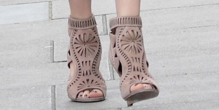 Claudia Schiffer complements her intricate wedge booties with a flawless pedicure