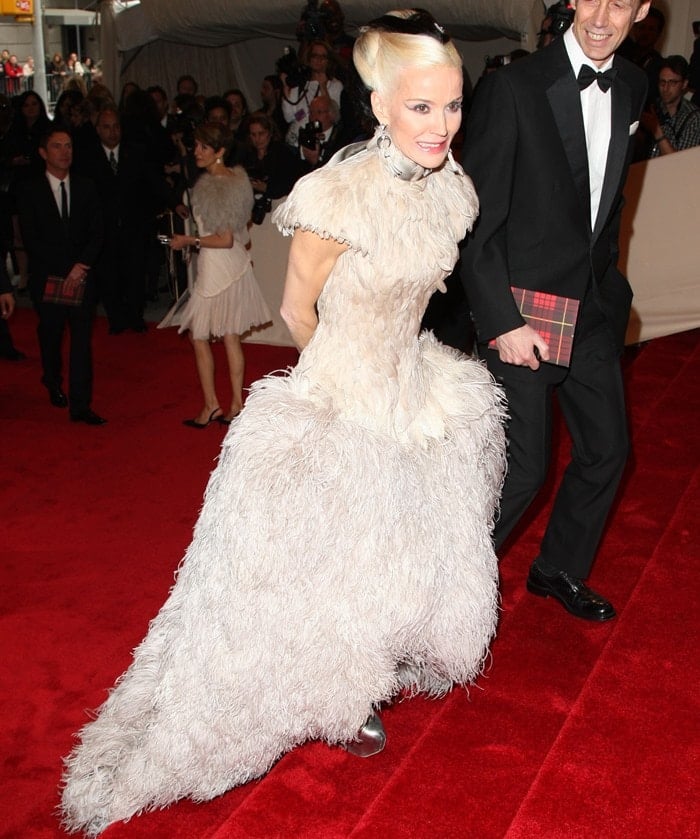 Daphne Guinness makes a dramatic entrance in avant-garde heel-less silver platform Mary Janes, effortlessly complementing her ethereal feathered gown at the Met Gala