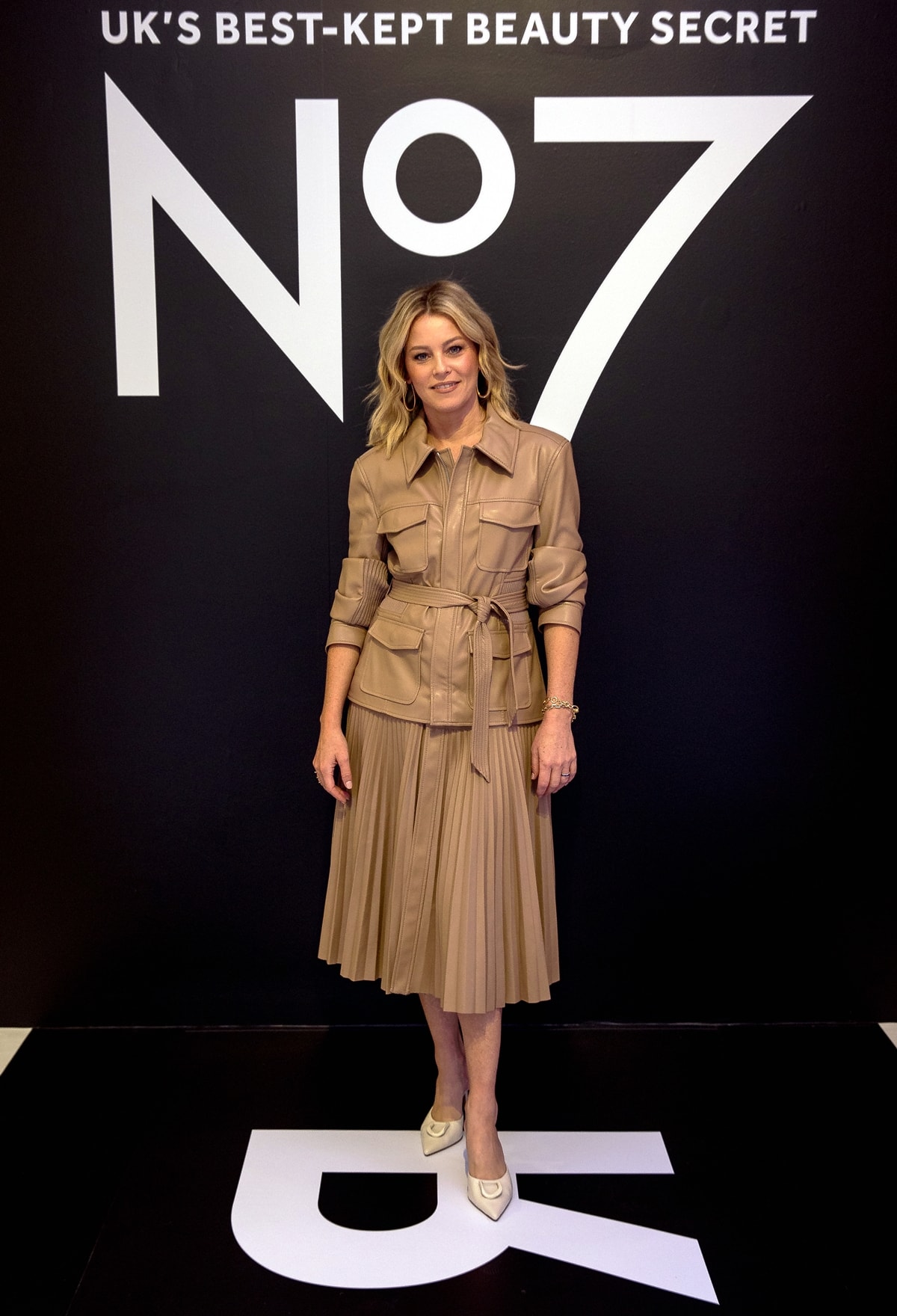 On October 26, 2023, Elizabeth Banks stepped out in a Jonathan Simkhai faux-leather pleated dress to celebrate being the first-ever U.S. celebrity spokesperson for No7 at their Future Renew Reversal lounge event in New York City