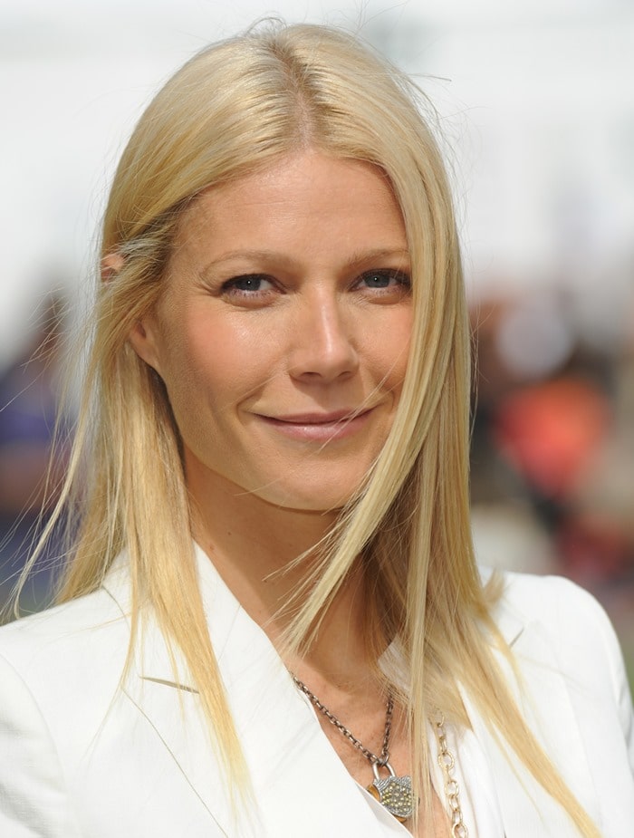 Gwyneth Paltrow radiates effortless elegance with her sleek, center-parted blonde hair, glowing minimal makeup, and a chic Isabel Marant Gaynor tencel and linen-blend blazer paired with a delicate Finn Angel Wing necklace