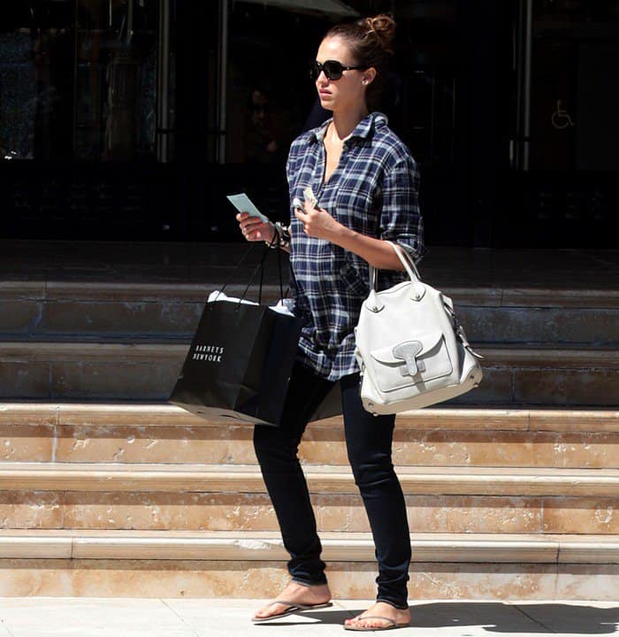 Jessica Alba gracefully displays her baby bump while departing from Barneys New York in Beverly Hills on April 26, 2011