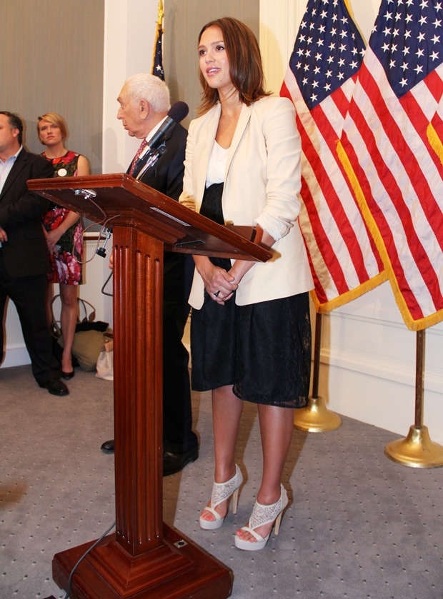 Jessica Alba wears Ann Taylor‘s “Urban” jacket and “Salt Silky” tee with a “Penelope” black lace skirt by Jane Oh