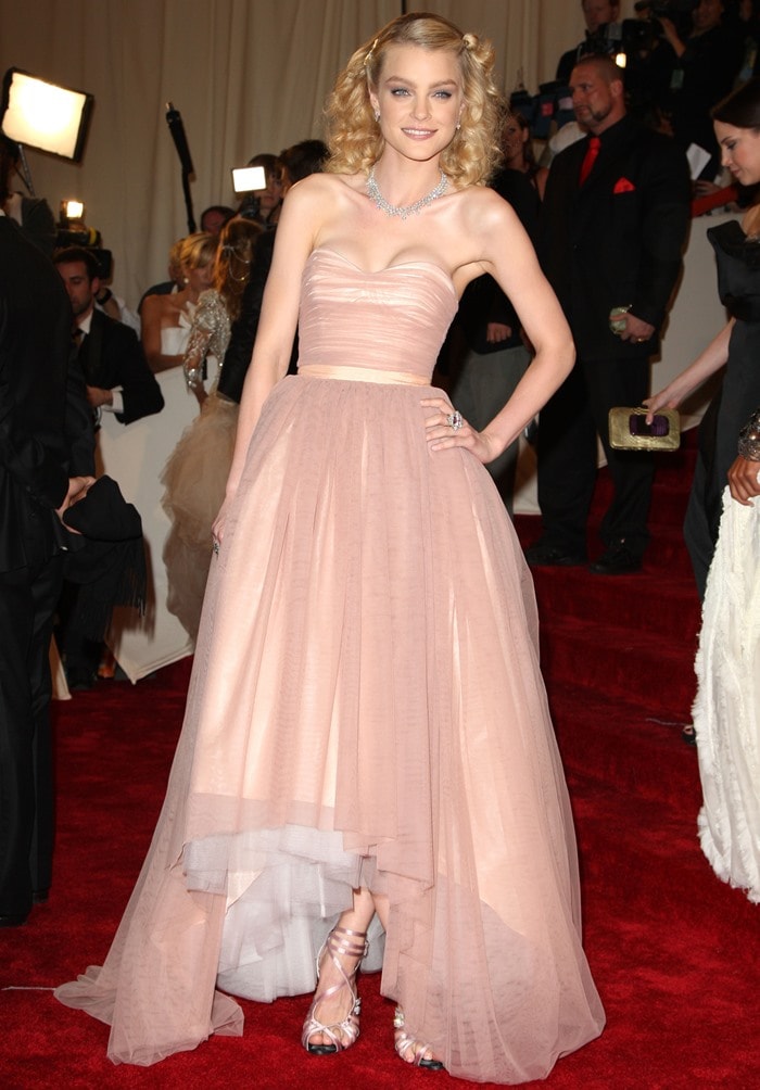 Jessica Stam stuns at the Met Gala in a dreamy blush-toned Tommy Hilfiger Collection gown paired with Roger Vivier heels, a Chopard necklace, and Cathy Waterman rings