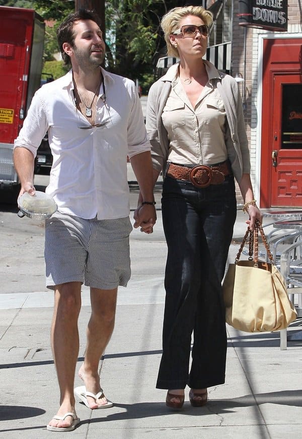 An intimate moment featuring Katherine Heigl and her husband Josh Kelley, hand-in-hand, post a delightful lunch date at Little Doms Cafe in Los Angeles, captured on May 10, 2011