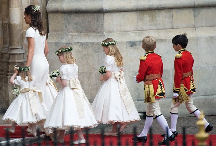 Pippa Middleton leads a group of bridesmaids and other wedding party members into Westminster Abbey for the wedding of Prince William and Kate Middleton