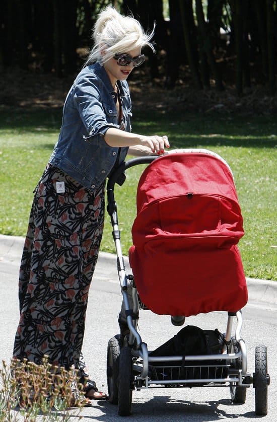 Gwen Stefani looked effortlessly chic at the Huntington Botanical Gardens on June 4, 2011, wearing an elegant Winter Kate Passenger halter neck maxi dress in silk chiffon, paired with a trendy AG Adriano Goldschmied Robyn denim jacket, and accessorized with distinctive Prada SPR 27NS round baroque sunglasses