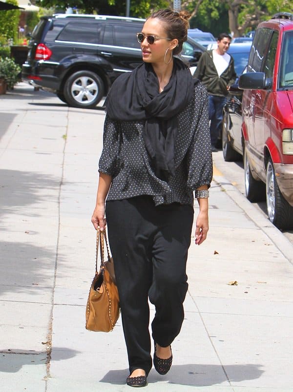 Jessica Alba at a Sunday brunch on May 29, 2011, wearing Theory Maternity Rosel pants, Jil Sander cutout flats, accessorized with a Love Quotes scarf, Valentino Rockstud leather shoulder bag, and Oliver Peoples sunglasses