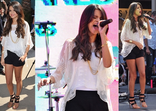 Selena Gomez performs in a loose white top paired with black shorts