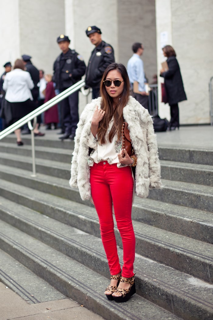 Aimee Song turns heads in bold red skinny jeans, a luxe faux fur coat, and statement leopard-print platform sandals—proving fearless fashion is all about balance and confidence