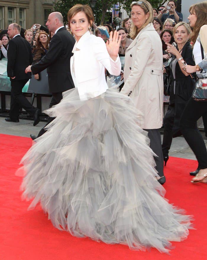 At the Trafalgar Square premiere of 'Harry Potter and the Deathly Hallows Part 2', Emma Watson exudes elegance and poise, draped in a chic white jacket