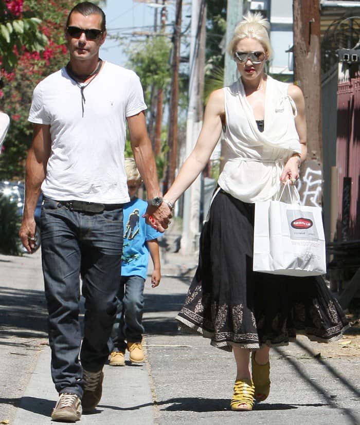 Gwen Stefani was looking unconventionally fashionable in a white wrap top paired with an ankle length black skirt and yellow bootie sandals