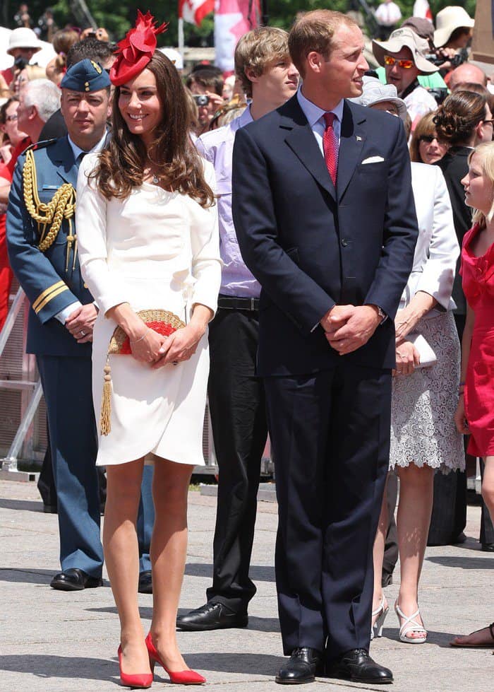 Kate Middleton's outfit at the Canadian Museum of Civilization on July 1, 2011, featured a cream and red Anya Hindmarch Straw Fan Clutch, a Hobbs Albini Square Cut Court, a Sylvia Fletcher for Lock & Co. Maple Leaf Red Hat, a Queen Elizabeth's Maple Leaf Brooch, a Garrard & Co Sapphire and Diamond Engagement Ring, a Reiss Nannette dress from Fall 2009, a Tiffany & Co. Elsa Peretti Diamonds by the Yard Bracelet in platinum, and an Asprey London 167 Button Pendant in 18K white gold with diamond & amethyst