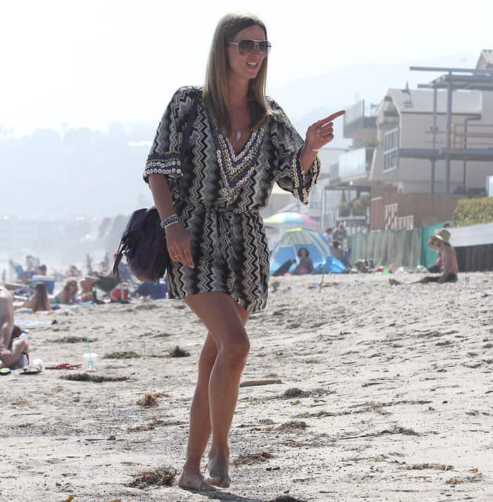 Bohemian meets elegance: Nicky Hilton showcases her unique style in a beaded black and grey tunic, mingling with friends at a beach party in Malibu, July 2, 2011