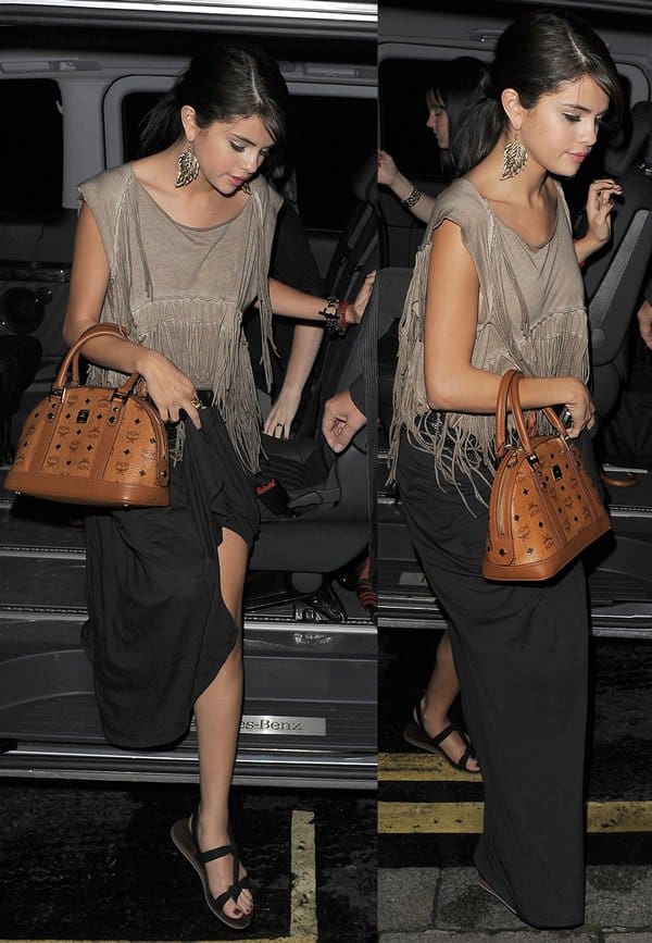 Selena Gomez keeps it effortlessly chic in an AllSaints Capri cropped top, an Alternative Apparel maxi skirt, and Cocobelle Noel thong sandals for a stylish night out at Nobu London on July 5, 2011