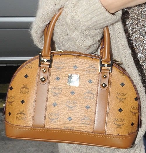 Selena Gomez proudly displays her stylish MCM bag, a perfect blend of modern fashion and classic design