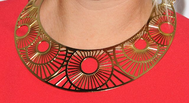 Statement Jewelry: A close-up of Maria Sharapova's exquisite gold-plated necklace, a striking accessory that complements her ensemble at the Pre-Wimbledon Party in London, June 16, 2011