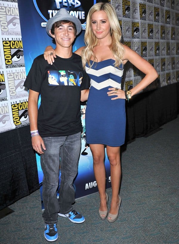 Blonde-again Ashley Tisdale stuns in a blue and white zig-zag strapless dress paired with peep-toe platform heels while promoting Phineas and Ferb alongside Vincent Martella at Comic-Con