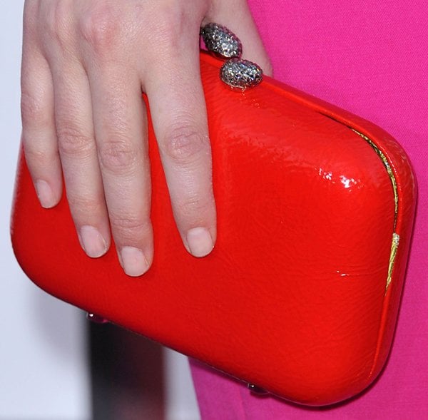 Rose Byrne toting a red patent Kotur clutch