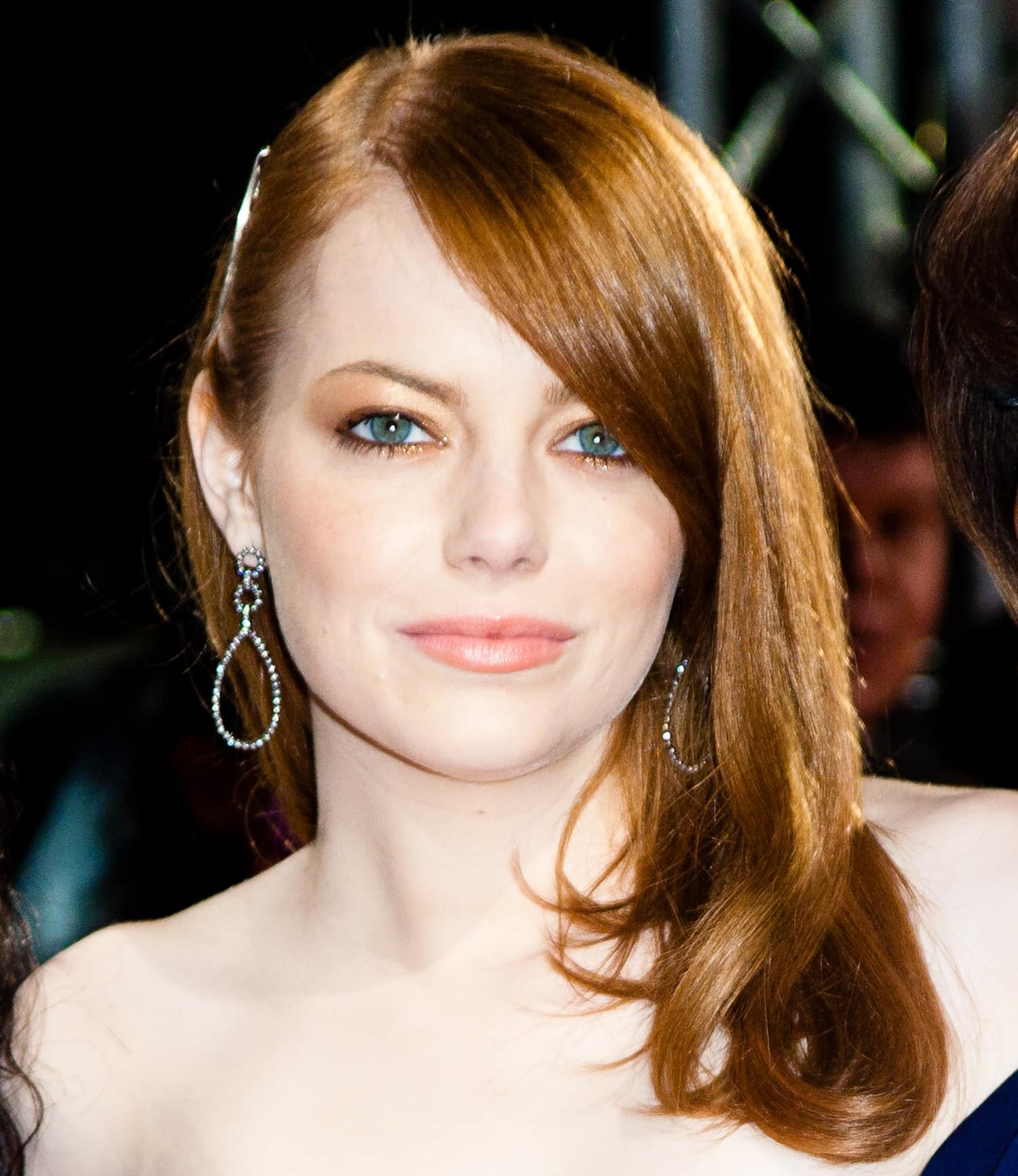 Emma Stone in a strapless Lanvin gown with a flawless hairstyle to show off her Dana Rebecca earrings at the premiere of The Help