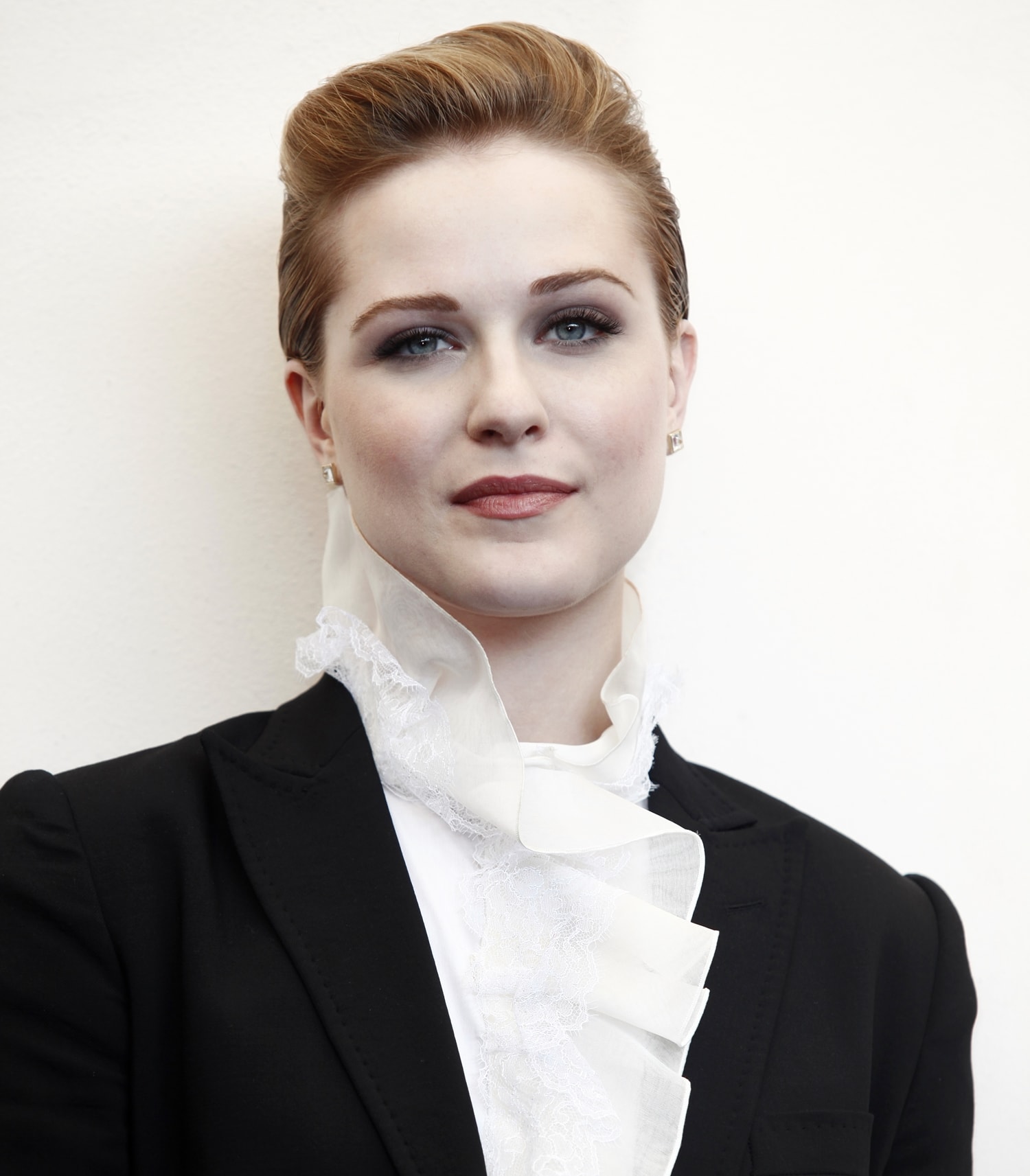 Actress Evan Rachel Wood wears a masculine Dolce & Gabbana suit and her hair in a short updo to show off her simple diamond stud earrings
