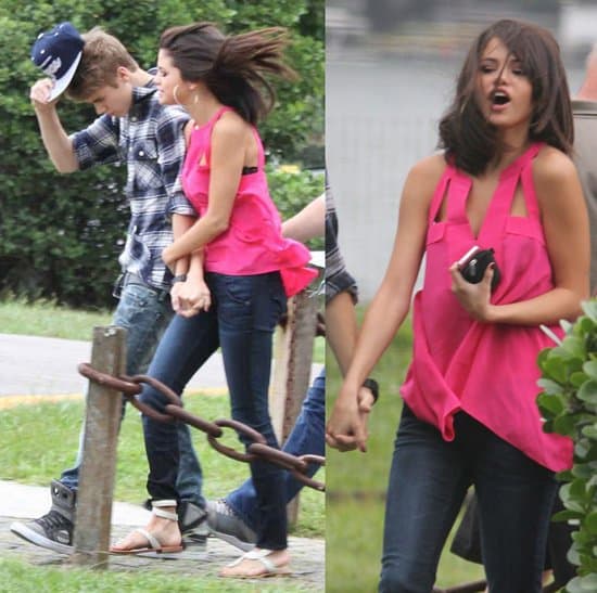 Selena Gomez styled a pink cutout top with dark blue jeans and white sandals