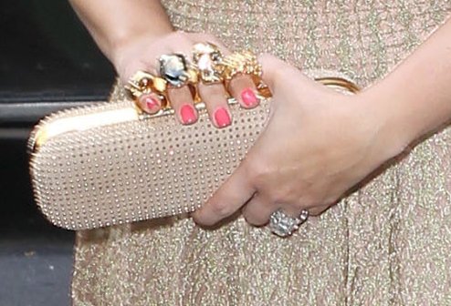 Kim Kardashian carries an Alexander McQueen knuckle duster studded suede clutch
