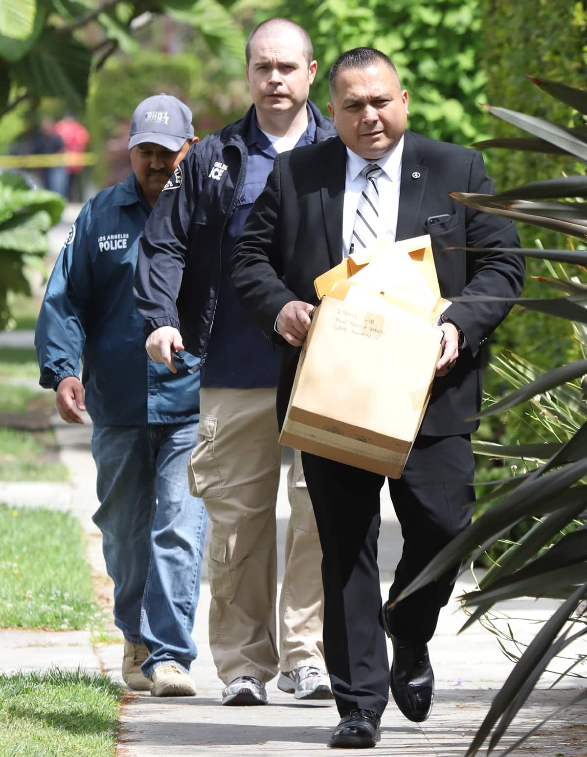 Gangs and narcotics investigators assigned are seen leaving the A$AP residence in Los Angeles