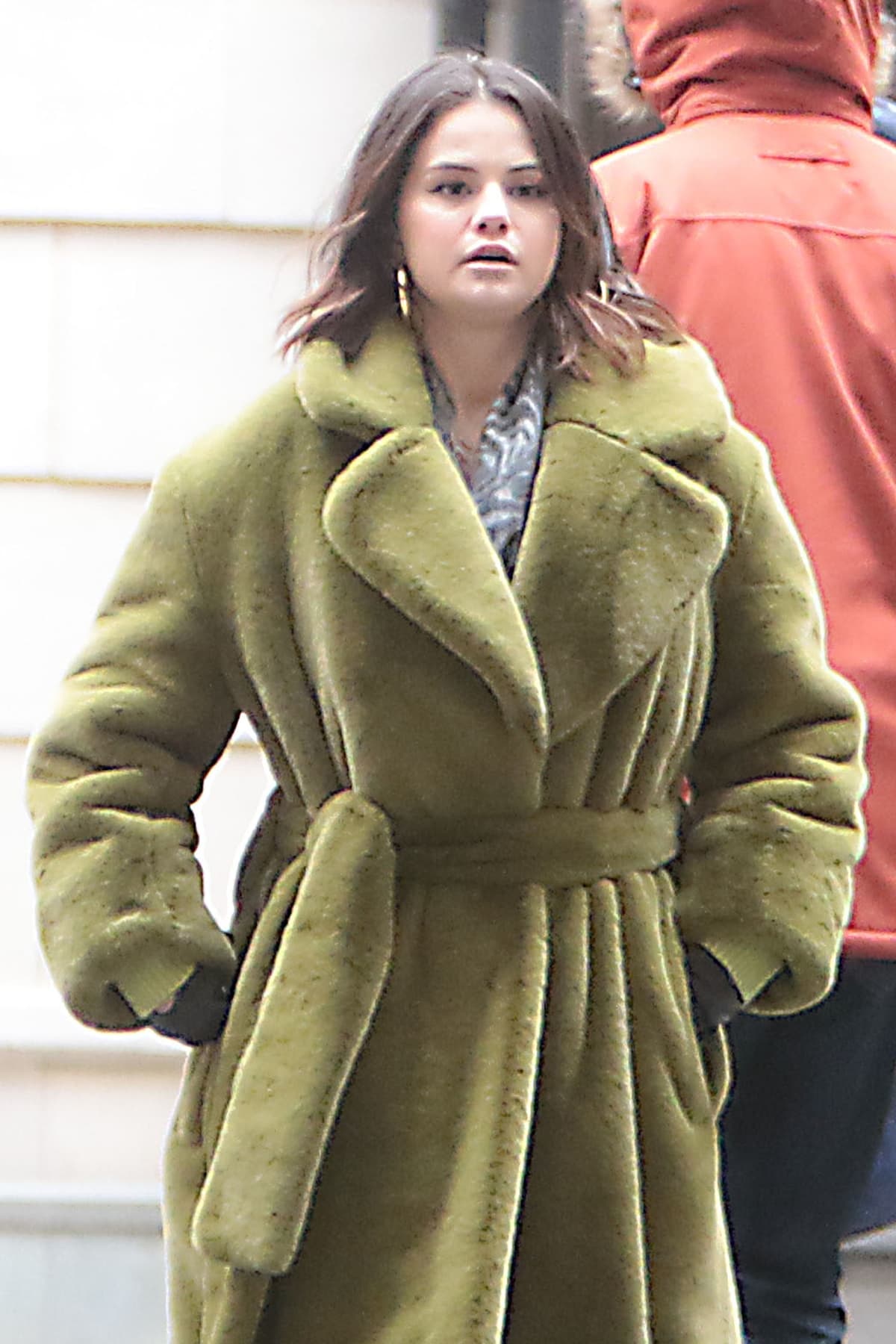 Selena Gomez wears a green Proenza Schouler faux-fur belted coat while filming Only Murders in the Building in New York City