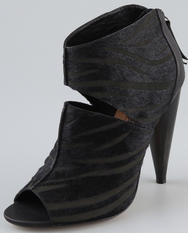 These black zebra-print haircalf booties feature an open toe and exposed back zip